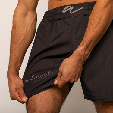 Unisex Jiu‑Jitsu training shorts in solid black; lightweight fabric with adjustable waistband