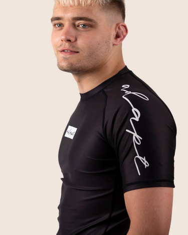 Men’s original BJJ rashguard in black, minimalistic design, 100% IBJJF legal. 