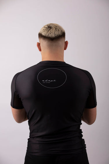 Men’s original BJJ rashguard in black, minimalistic design, 100% IBJJF legal. 